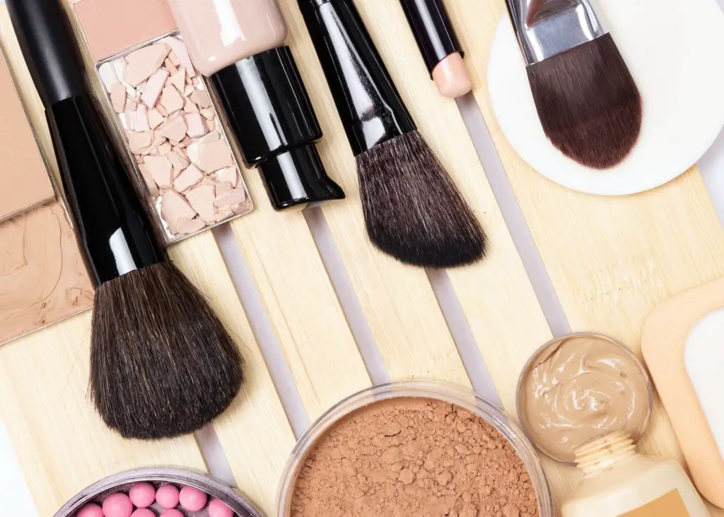 Concealer, primer, foundation, powder, blush with make-up brushe